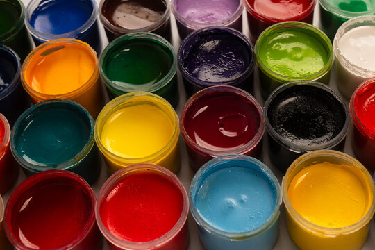 Gouache colorful paints set. Jars of gouache paint isolated on a white background.