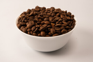 Fototapeta premium Coffee beans on a white background. Top view. Coffee beans texture.