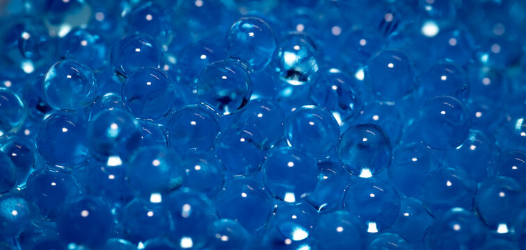 A close-up of blue hydrogel beads lying like fairytale pearls.