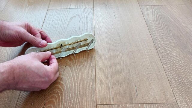 Hands demonstrate repairing a broken power strip by revealing internal components and reassembling the device, showcasing household electrical maintenance and practical repair techniques