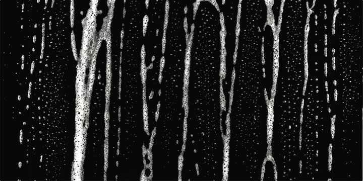 Abstract vertical streaks of white foam and bubbles on a dark black background, representing liquid or soap suds texture