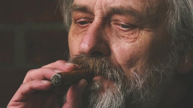 Older man smoking on balcony classic big cigar in detail video footage