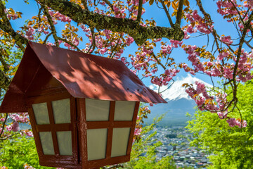 Wooden lantern in Arakurayama Sengen park with beautiful view on Mount Fuji in background