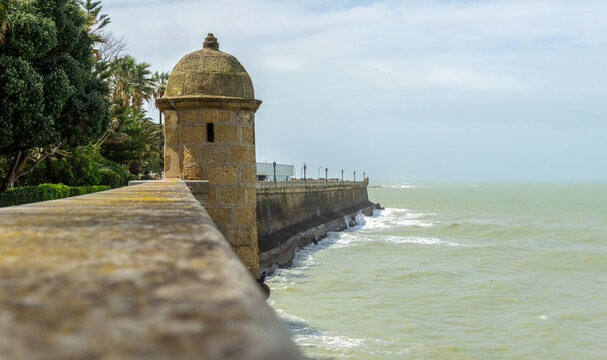 Cadiz Spain Historic Sea Wall and Sentry Box or Bartizans in Atlantic Ocean Coastline Traditional Military Architecture in Andalusia with Crashing Waves