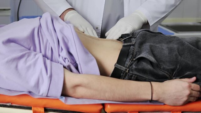 Urologist performs renal palpation to evaluate kidney tenderness during a physical examination 4k video.