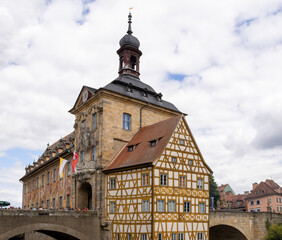 Fototapeta premium Altes Rathaus in Bamberg, Bavaria, Germany, iconic old town hall on an artificial island in the Regnitz River, connected by pedestrian bridges including Untere Brücke, featuring porcelain museum 
