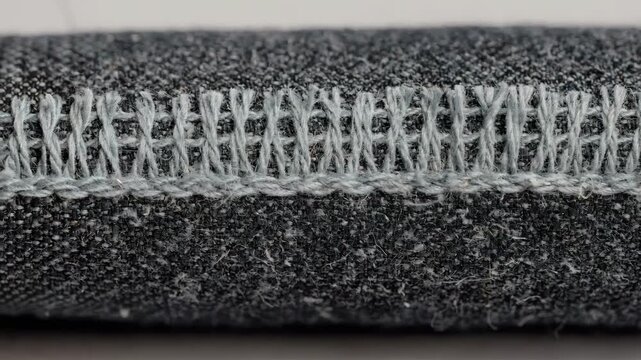 Detailed medium shot focusing on leno selvage edge with twisted warp threads showcasing unique stability in woven cloth.