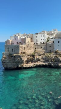 Cliffside houses of Polignano a Mare above turquoise Adriatic Sea, Italy