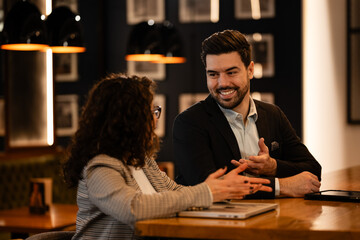 Business professionals discussing work during a networking meeting