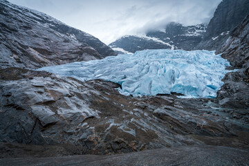 Nigardsbreen Glacier with Blue Ice and Rocky Valley in Norway