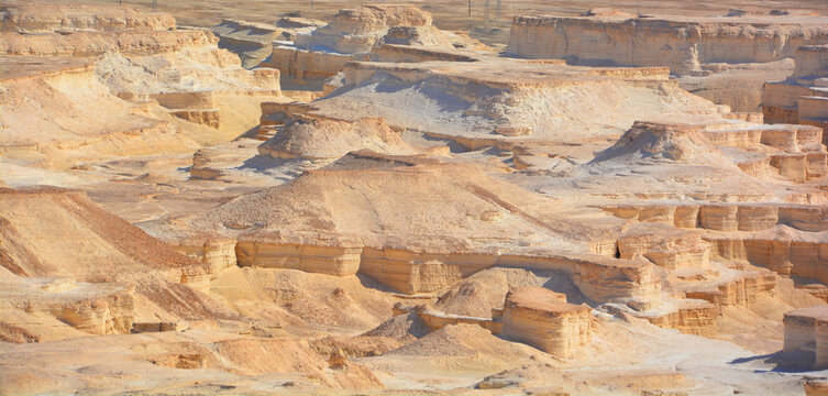 Rocky hills of the Negev Desert in Israel. Breathtaking landscape of the desert rock formations in the Southern Israel Desert. Dusty mountains interrupted by wadis and deep craters.