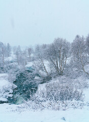 Snowy River in Nordic Winter Landscape During Snowfall