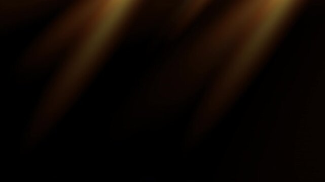 Looping sun rays golden flare light effect with shine on black background
