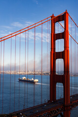 Fototapeta premium A cargo ship just after crossing the Golden Gate Bridge with the San Francisco skyline in the background