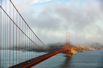 Fototapeta premium The Golden Gate Bridge with one of its pylons covered in the famous fog (Karl)