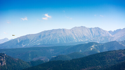 Obraz premium beautiful landscape of mountain range in poland, europe. panoramic travel background of high tatra in summer. scenic view of alpine region for picturesque journey in the afternoon