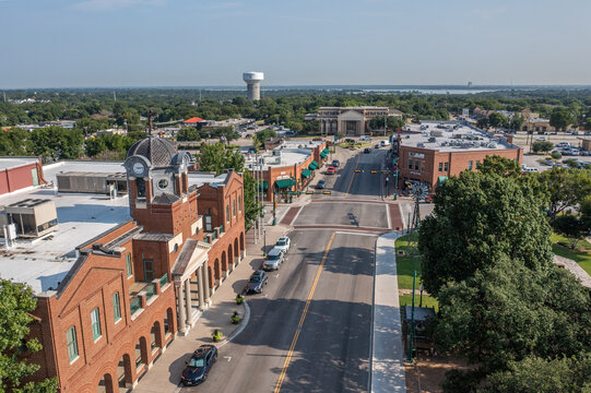 Aerial Drone View of Buildings and Street With Parked Cars With Water Tower in Downtown Grapevine, Texas