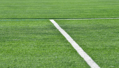 Obraz premium Green artificial turf with white penalty area lines
