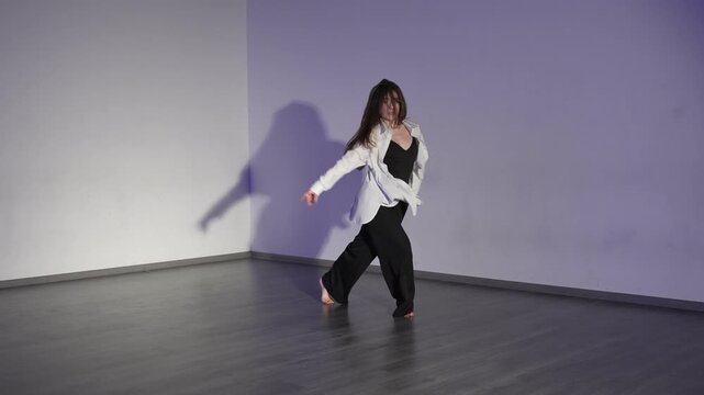 Contemporary dance female dancer expressive movement performance in minimalist studio space