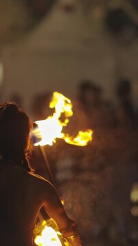 A woman performing a fire show outdoors