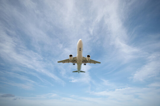 A huge passenger plane is landing in airport of Phuket, Thailand, a bottom view 