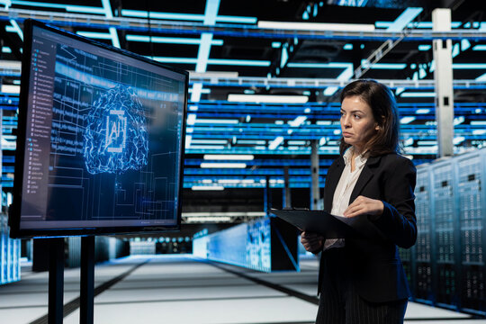 Data center computer scientist using AI to troubleshoot backend operations gear. Server hub worker running deep learning software development program on large display, resolving system crashes