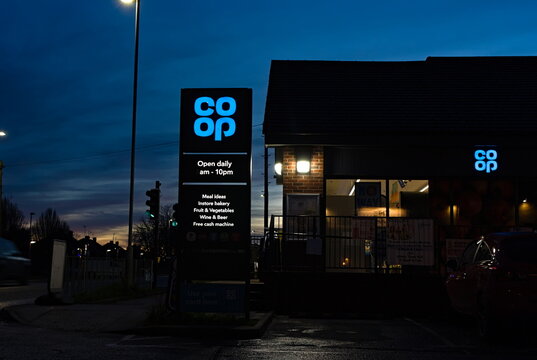 Co-op convenience store with lit up sign after sundown on London road. Wyberton Lincolnshire UK. Dec 2025