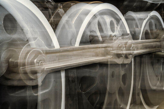 A close up of a train wheel with a blurry background