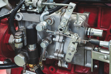 Close-up of diesel piston or gas engine generator fuel pump with many metal fuel and rubber lines...