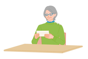 Senior woman checking envelope with both hands at desk