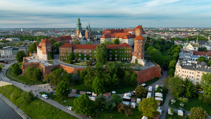 Fototapeta premium Aerial view of Wawel Castle in Krakow with historic fortifications, cathedral towers, royal courtyard and city skyline on a clear spring day in Poland
