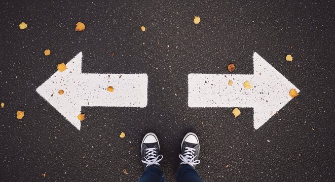 Persons Feet on Asphalt with Arrows Pointing Left and Right