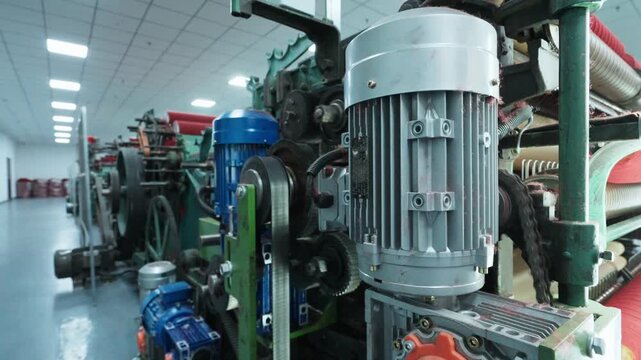 Close-up of large industrial electric motor equipment in a factory workshop