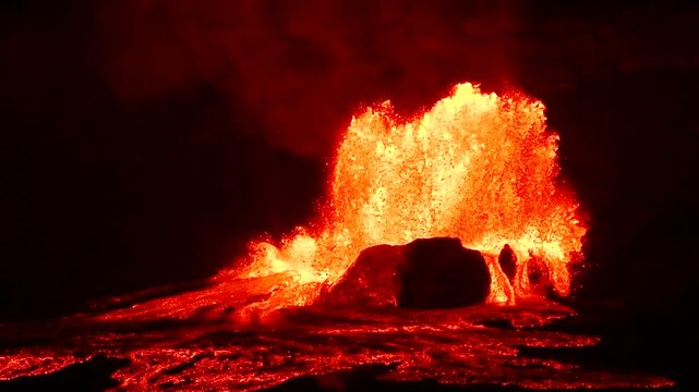 Slow motion night footage of the Kilauea volcano eruption at Halemaumau crater, with lava fountains rising up to 1000 feet in Hawaii Volcanoes National Park, Big Island, Hawaii.