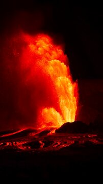 Slow motion night footage of the Kilauea volcano eruption at Halemaumau crater, with lava fountains rising up to 1000 feet in Hawaii Volcanoes National Park, Big Island, Hawaii.