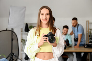 Female photographer with camera during courses in studio