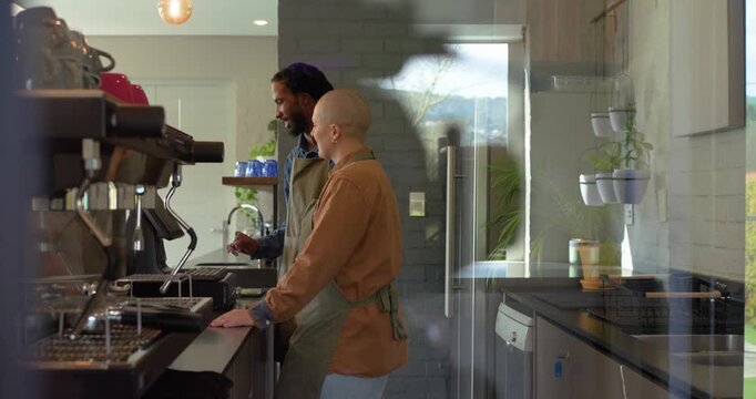 Baristas gesturing portafilter locking into machine checking gauge and serving coffee at counter