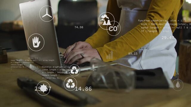 Woman typing on laptop, updating HUD CO2 and bar charts around hands, monitoring eco metrics