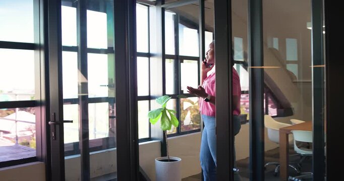 Phone ringing African American woman walking glass office, calling client, closing deal, copy space