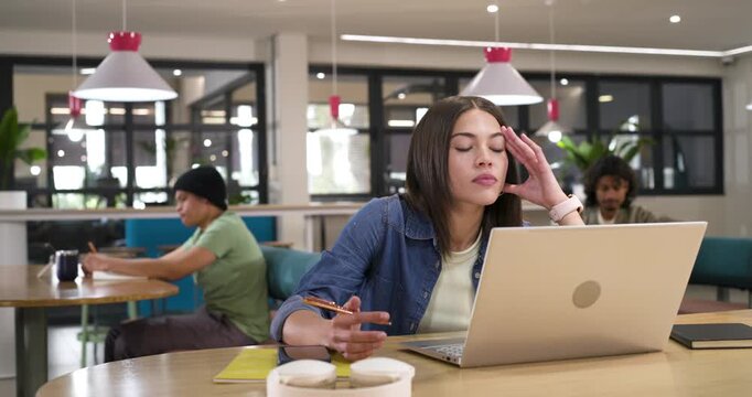 African American coworkers observing woman using laptop experiencing fatigue, fidgeting with pen