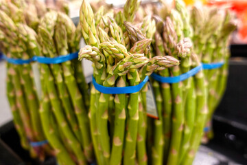Bunches of asparagus on the shelf in grocery store