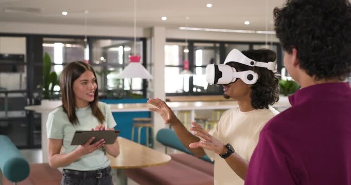 African American team in office woman tapping tablet guiding VR user testing demo, copy space