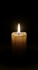 A single lit candle burning brightly in the darkness.