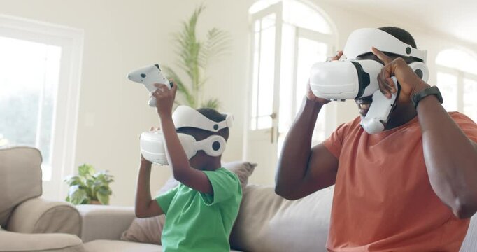 VR game starting, father and son are reacting on sofa, adjusting headsets and sharing controller