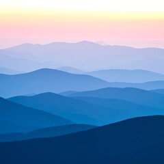 Obraz premium Serene layered mountain silhouettes in shades of blue and violet under a pastel sky