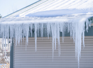 winter house with icicle and snow on the roof