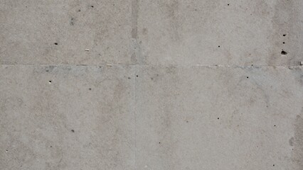 Close-up concrete wall composed distinct sections each section light grey blocks arranged grid-like pattern evenly