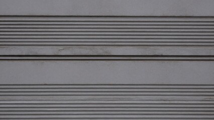 Obraz premium Close-up gray corrugated metal surface vertical lines running horizontally creating pattern texture rough uneven visible