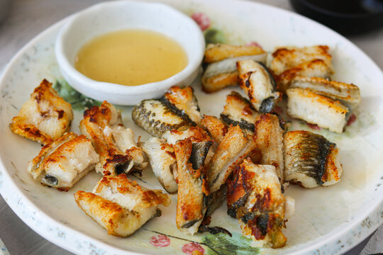 A delicious plate of perfectly grilled seasoned and salted eel, featuring a crispy exterior and succulent, tender meat.