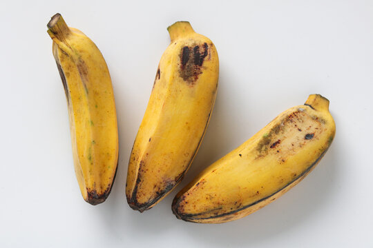 Top-down view of three saba bananas (pisang kepok) isolated on a white background.